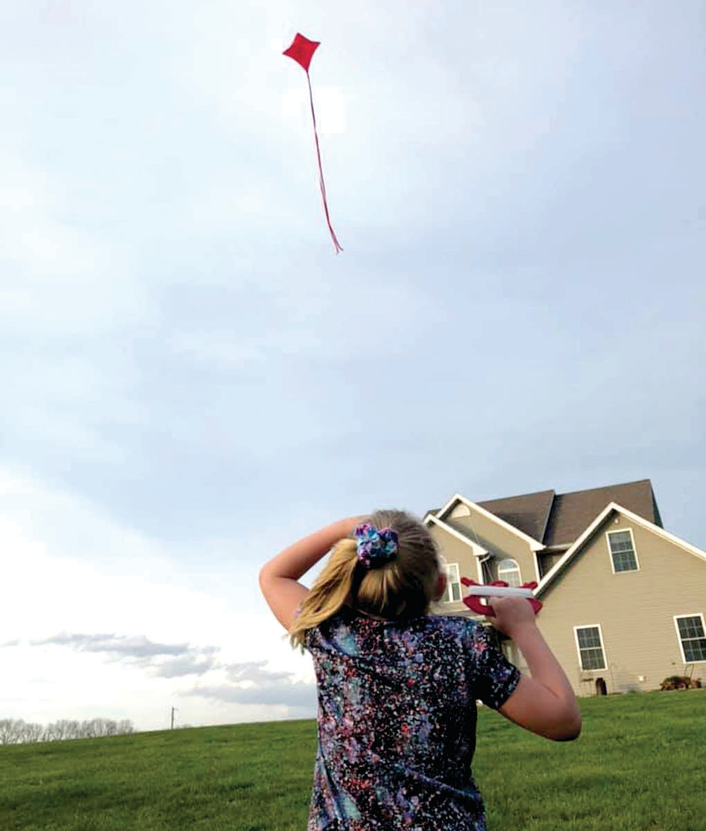 The Hall family in Linn has been taking advantage of the beautifully breezy weather and flying kites. Grace is shown here flying her kite.