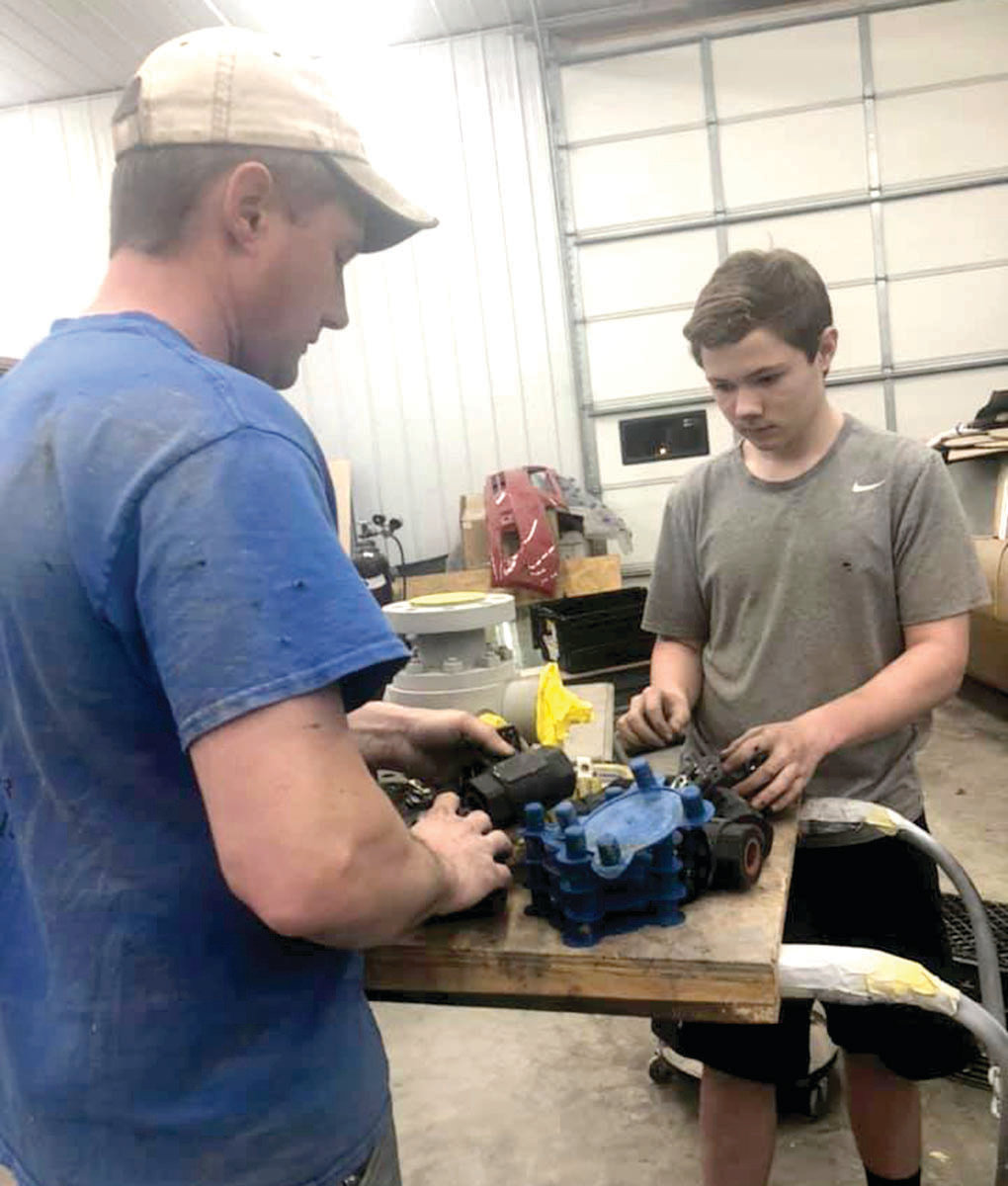 Shane Greer works in the shop with his father, Travis.
