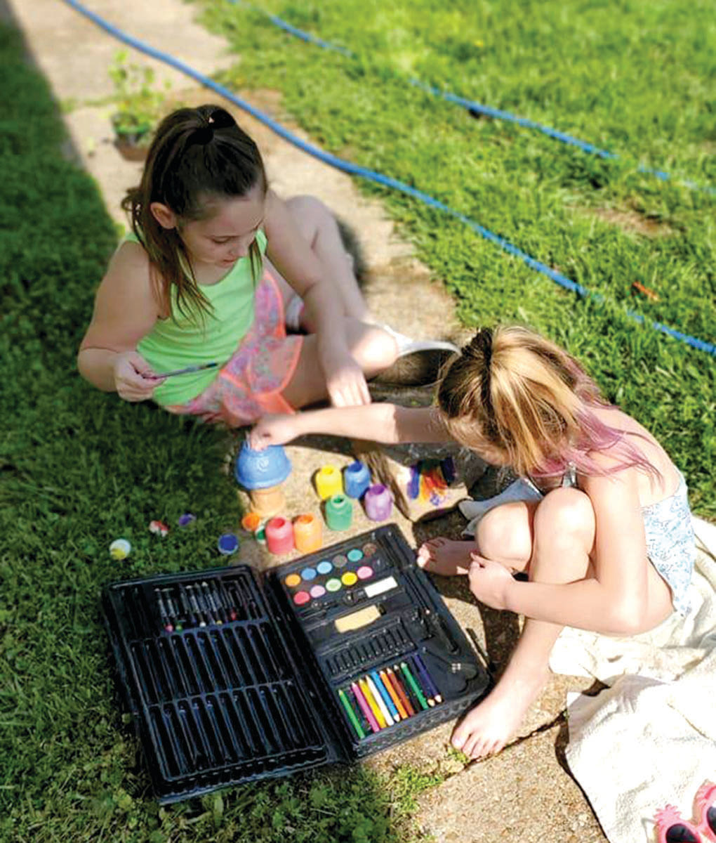 Blaise Deatsch and Kirra Deatsch enjoy time playing with colored chalk.