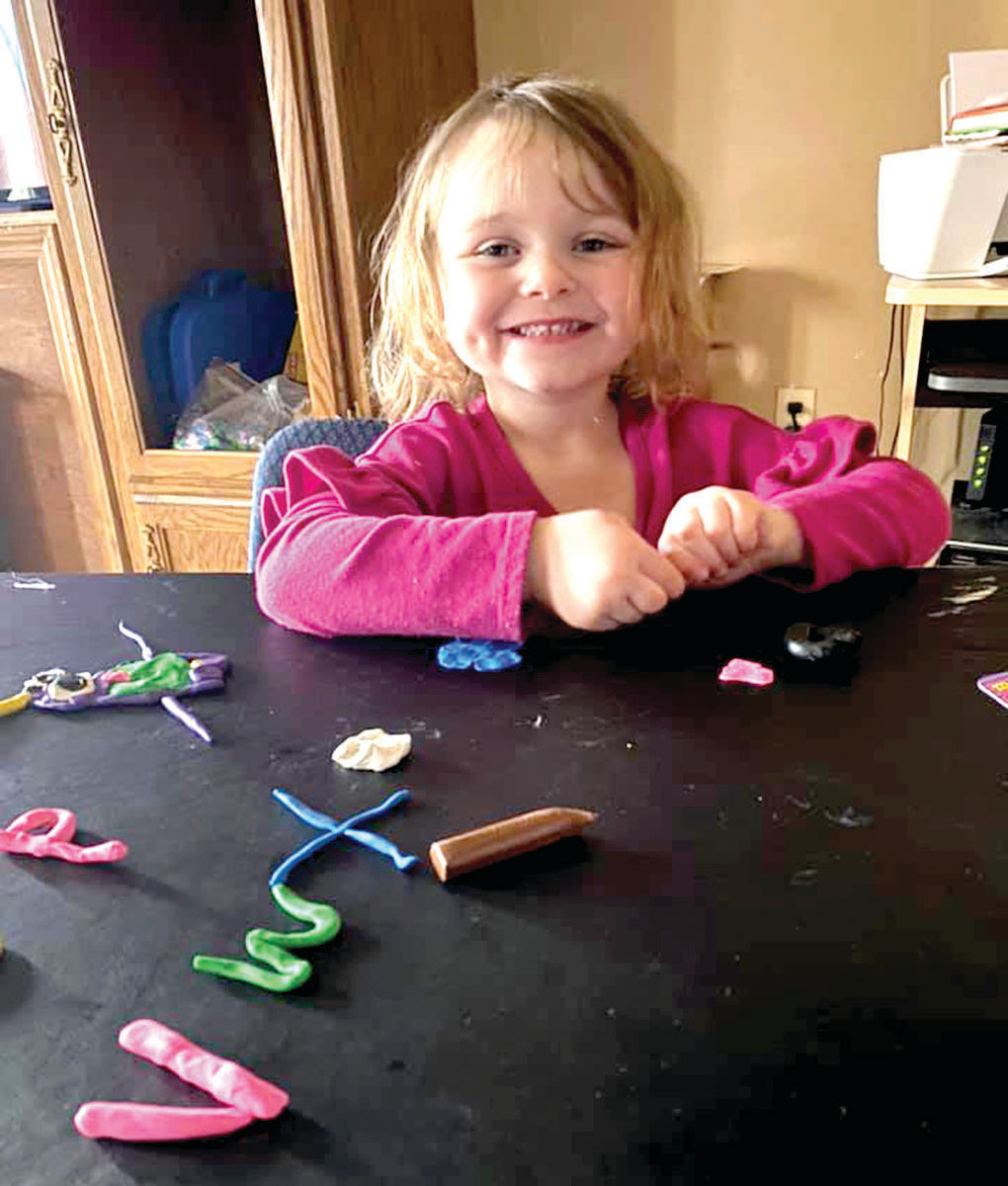 Rylee Sneller plays with ABCs and monsters made of clay.