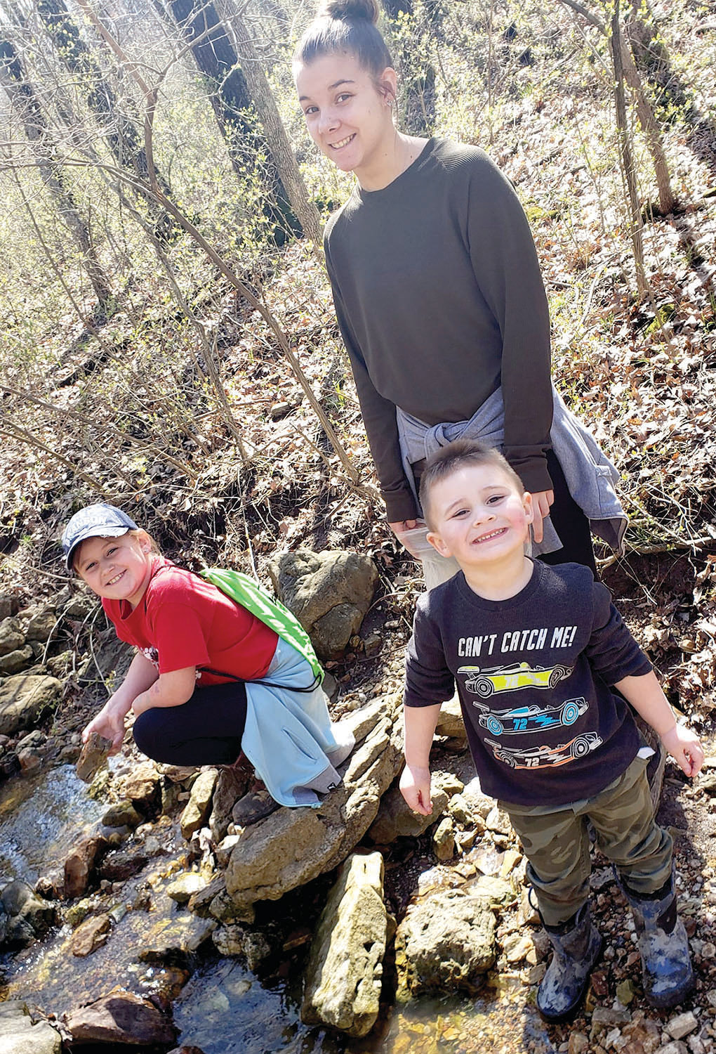 Kylie, Andi and Raylan Wolfe enjoy time at the creek behind their house.