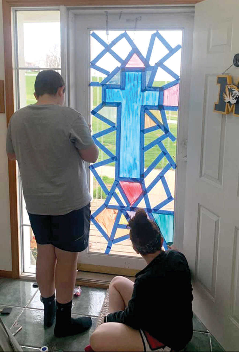 Britt and Blaine Winslow paint the front door.