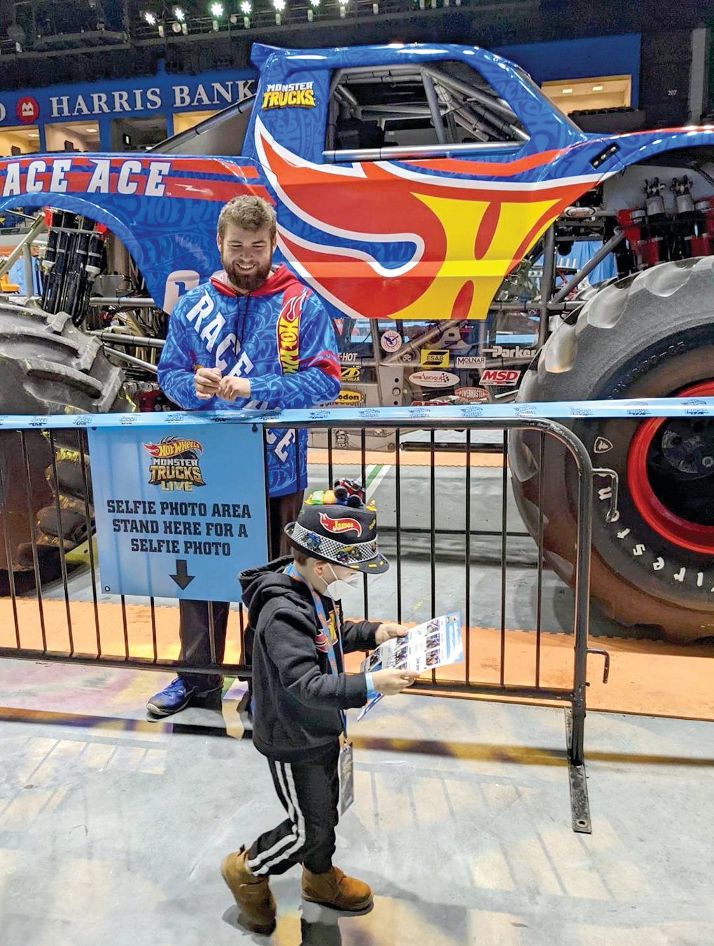 BIGFOOT driver Eric Steinberg smiles as a young fan studies an autograph provided by the State Tech student who will become a full-time driver after graduation this month.