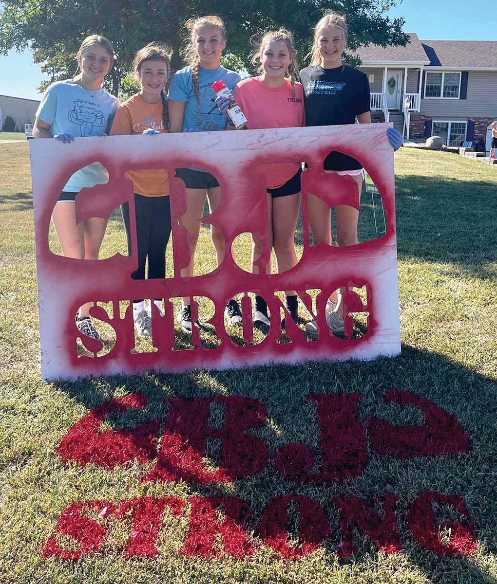 Elli Dudenhoeffer, Anna Peters, Heslie Higginbotham, Brynlee Ferguson, and Paige Senevey paint a yard stencil with the logo, “BJ Strong” recently with help from Jason Dudenhoeffer.