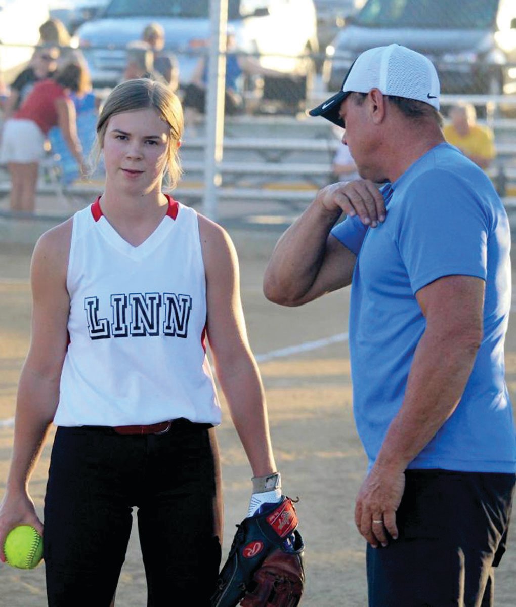 BJ Kaullen gives his daughter, Lydia, pointers, during a recent softball game.
