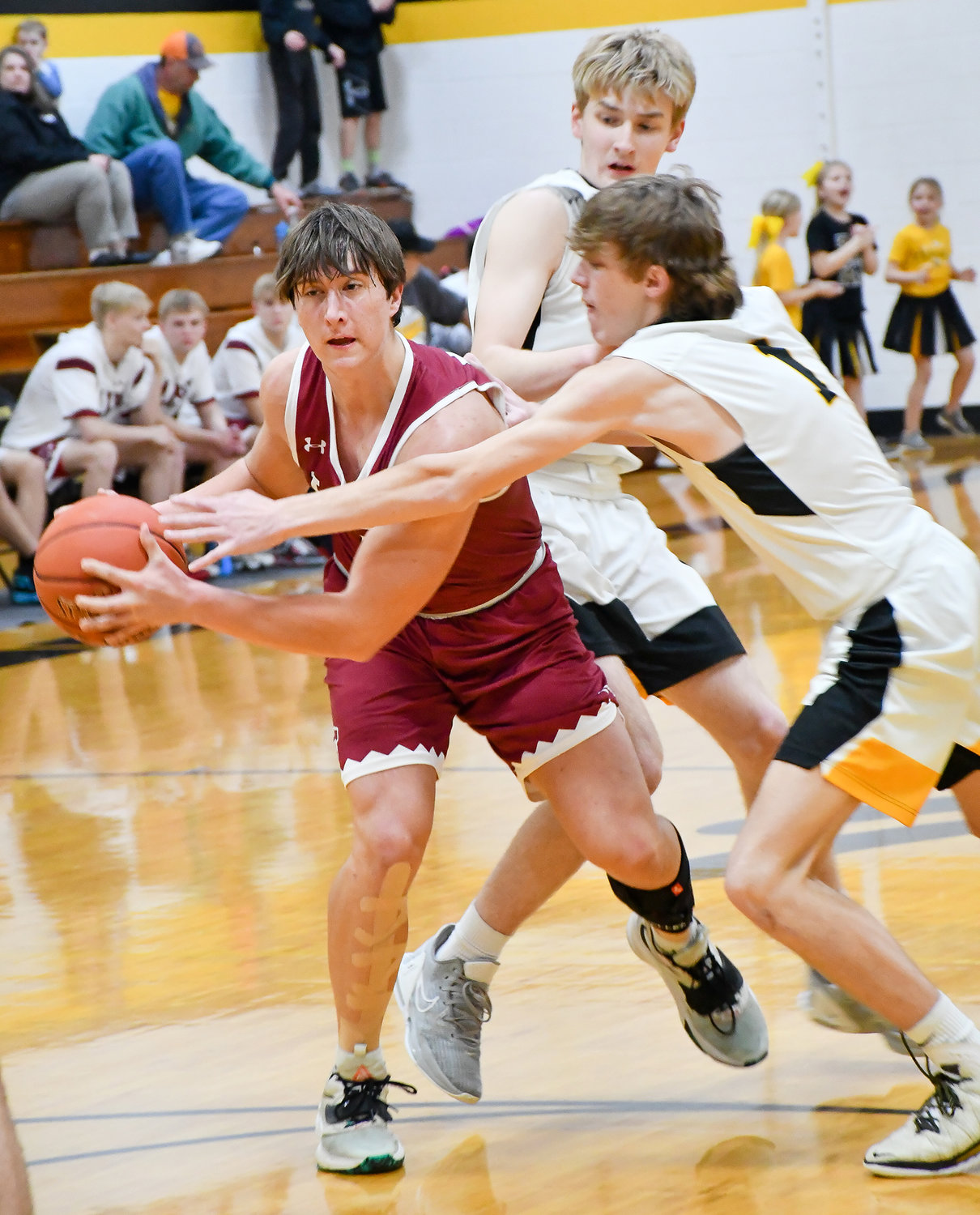Seth Wolfe looks to get away from two St. Elizabeth defenders in last week’s game on the road.