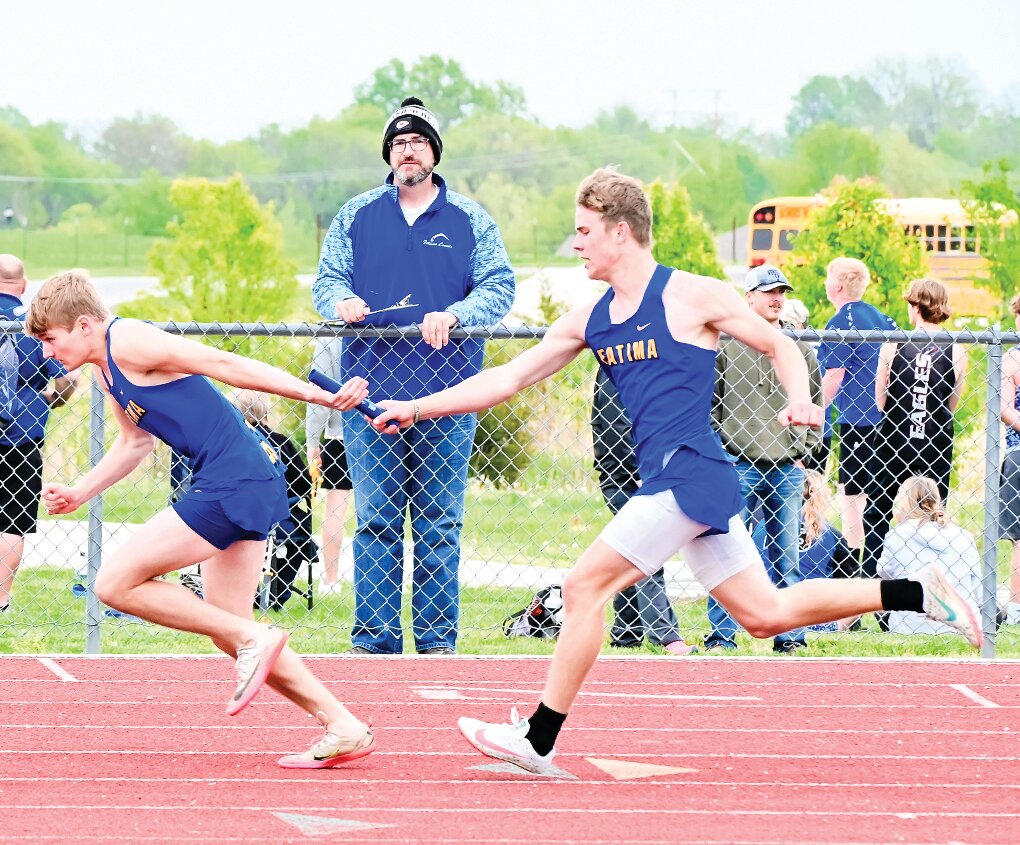 Tyler Koenigsfeld hands the baton to Tyler Kloeppel in Friday’s conference 800m relay at New Bloomfield.