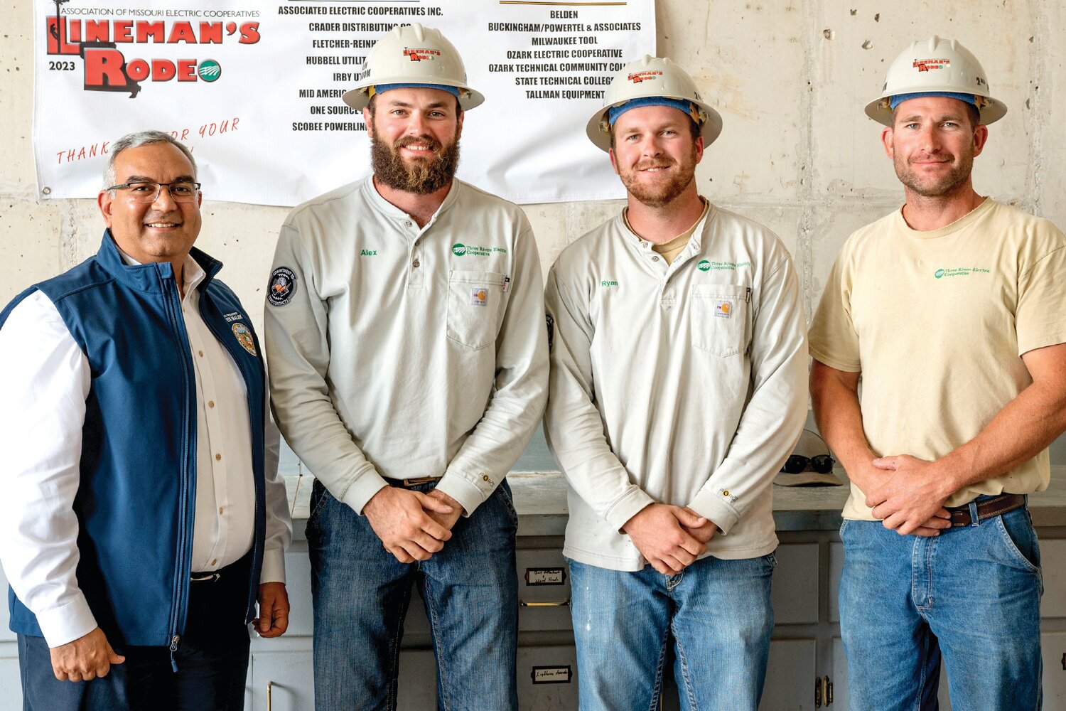 Missouri State Treasurer Vivek Malek, left, presents TREC linemen Alex Buschjost, Ryan Deeken, and Cory Kleffner, with their second-place hardhat trophies, at the sixth annual Lineman’s Rodeo recently. In addition, they each received first-place honors in timed individual events.