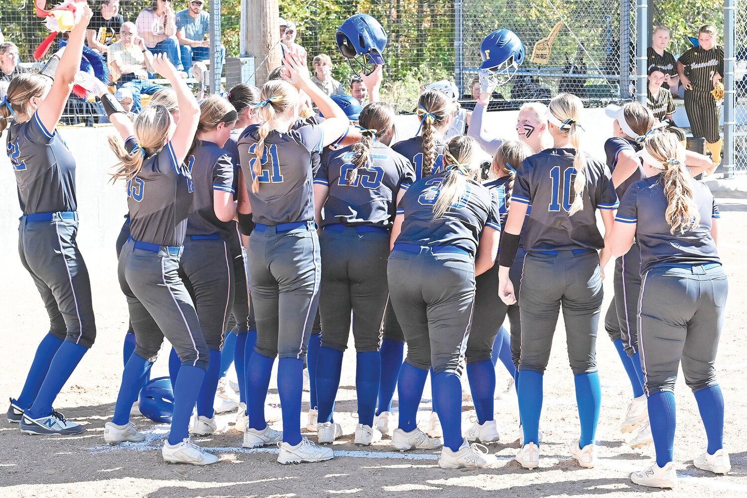Fatima players celebrate Kenzy Woody’s second home run during Saturday’s Class 3 quarterfinal at Westphalia. The Lady Comets defeated Cassville 14-0 in five innings.