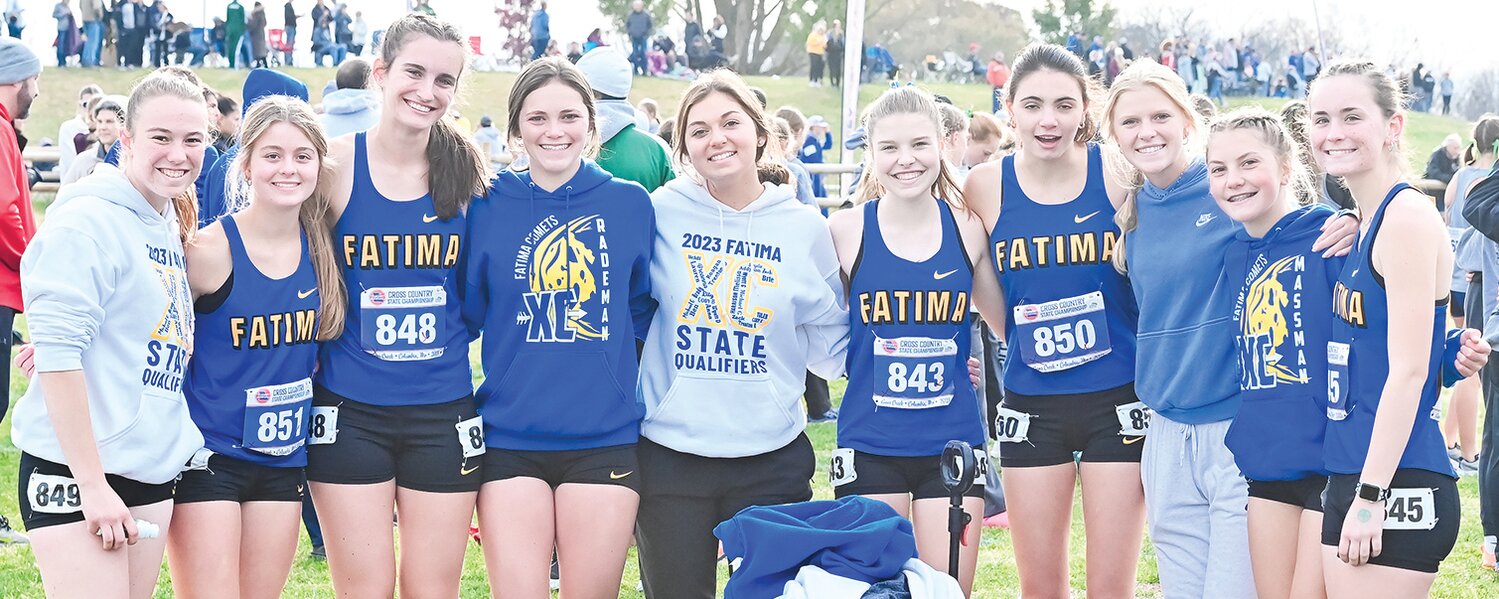Fatima runners pose before the start of Saturday’s Class 3 state championship race. Every member of the team set a new personal best in the meet on the way to a fifth-place finish. At right, Coach Marc Bridges hugs All-Stater Lauren Behorst (11th) after presenting her medal while Brie Massman (25th) looks on (back left).