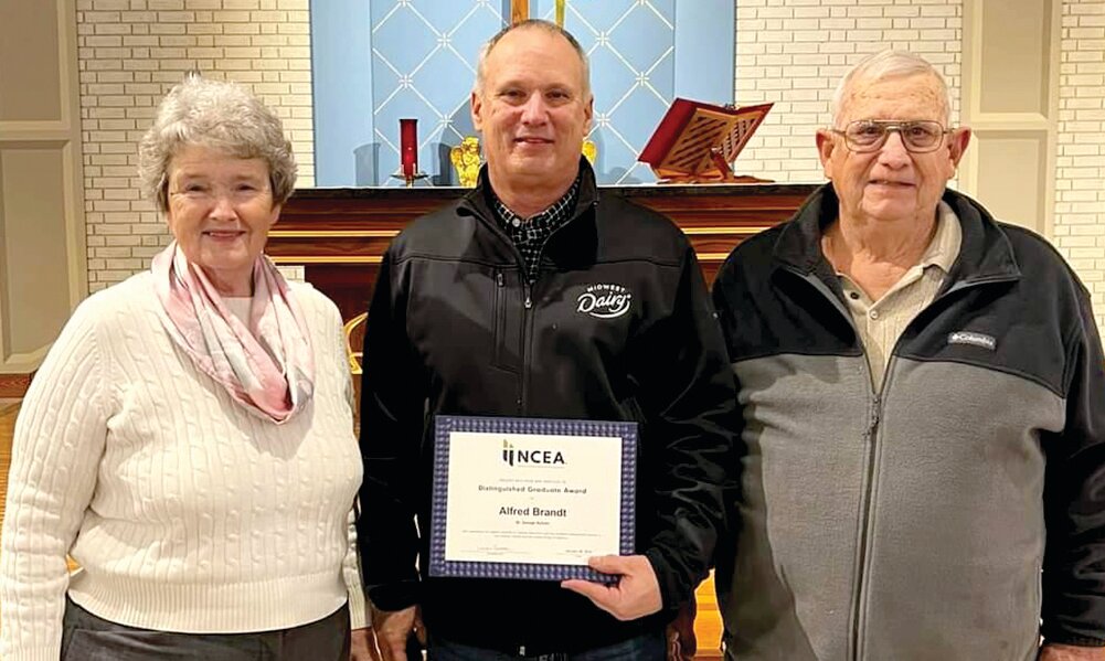 Alfred Brandt of Linn, a 1981 graduate of St. George, is shown with his parents, Christy and Don, after receiving his National Catholic Education Association (NCEA) Distinguished Graduate Award.